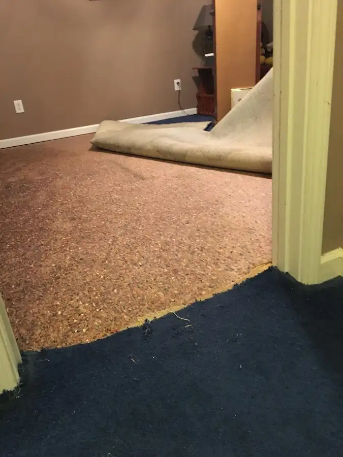 Carpet pad removal revealing water damage during Drying & Dehumidification in Weisenberg